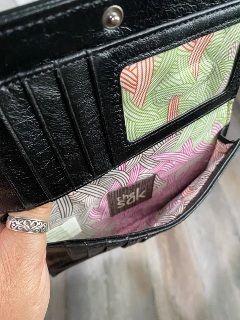 The Sak Black Quilted Eyelet Trifold Leather Wallet with Logo Plaque